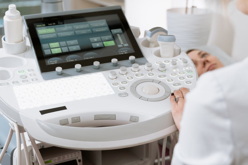 Close-up of a professional conducting an ultrasound examination in a modern medical clinic.